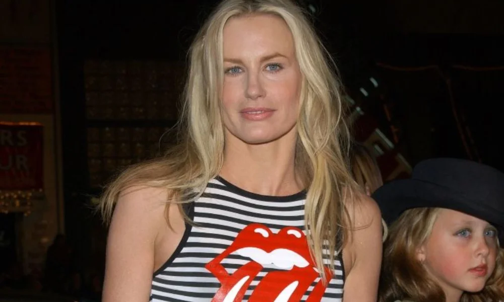 A woman with long blonde hair wearing a striped tank top-daryl hannah net worth