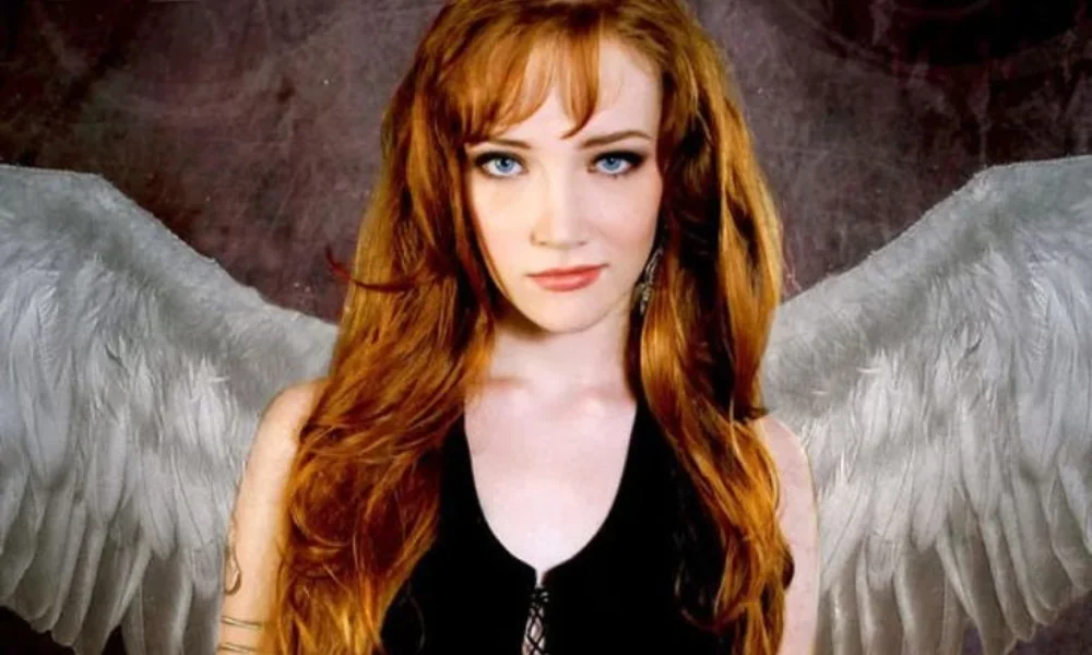 A woman with long red hair and blue eyes