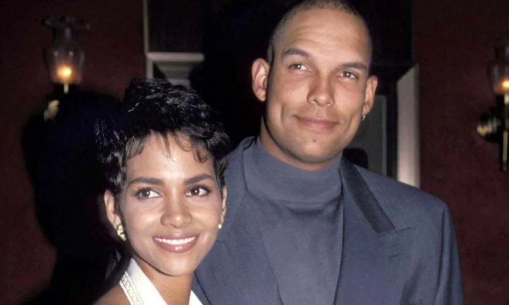 A smiling couple poses in a dimly lit setting-david justice net worth