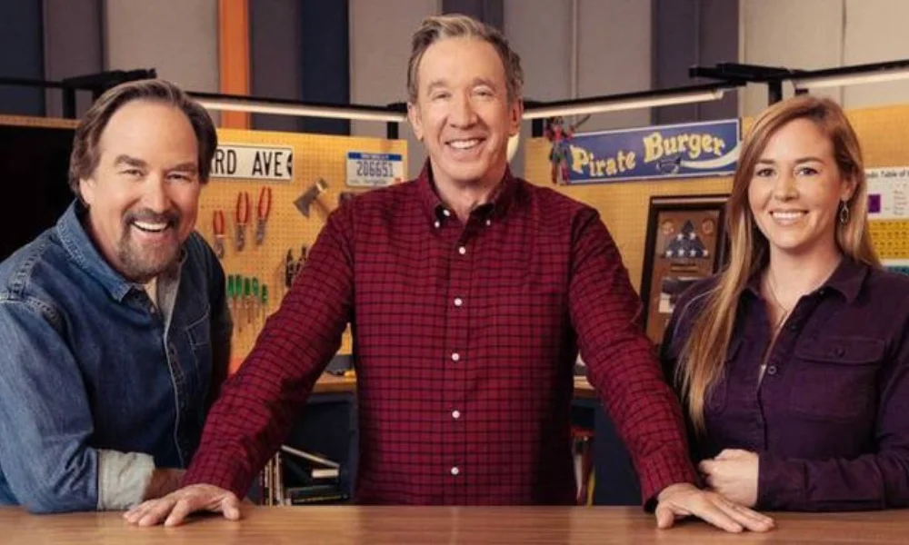Three people smiling in a workshop setting