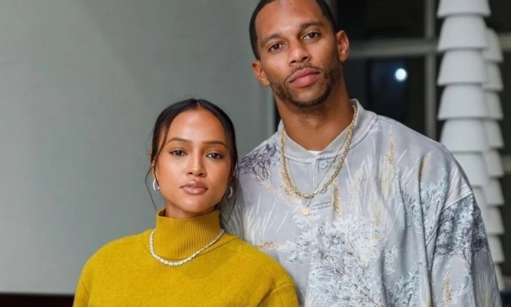 A couple poses together indoors-karrueche tran net worth