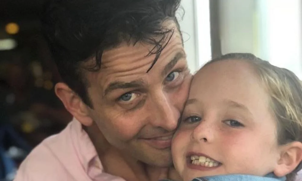 A man and a child share a close embrace-joey mcintyre net worth