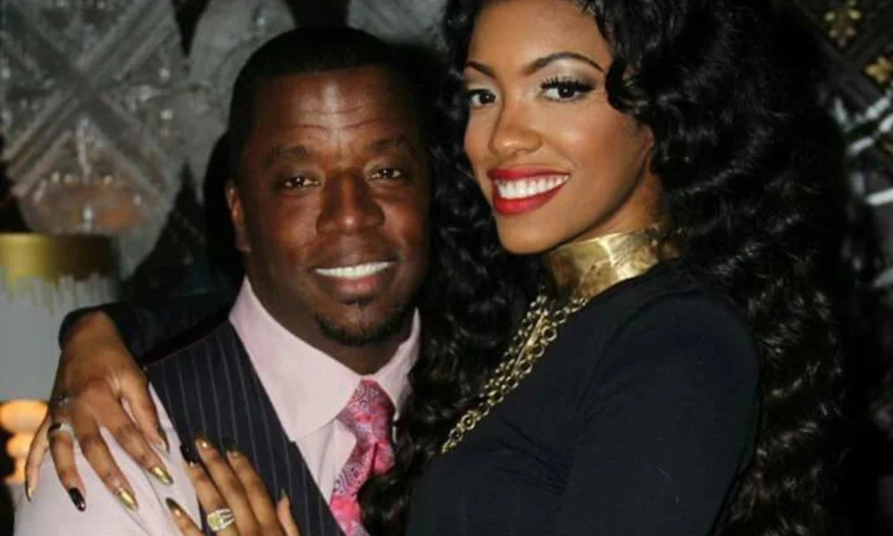 A smiling couple poses closely