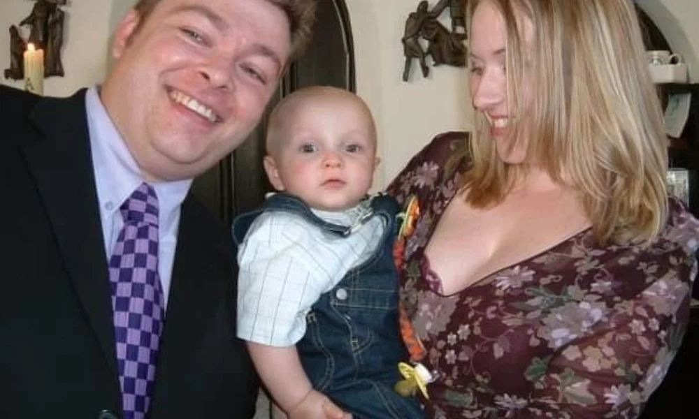 A happy family photo shows a man in a suit smiling widely-richard karn net worth