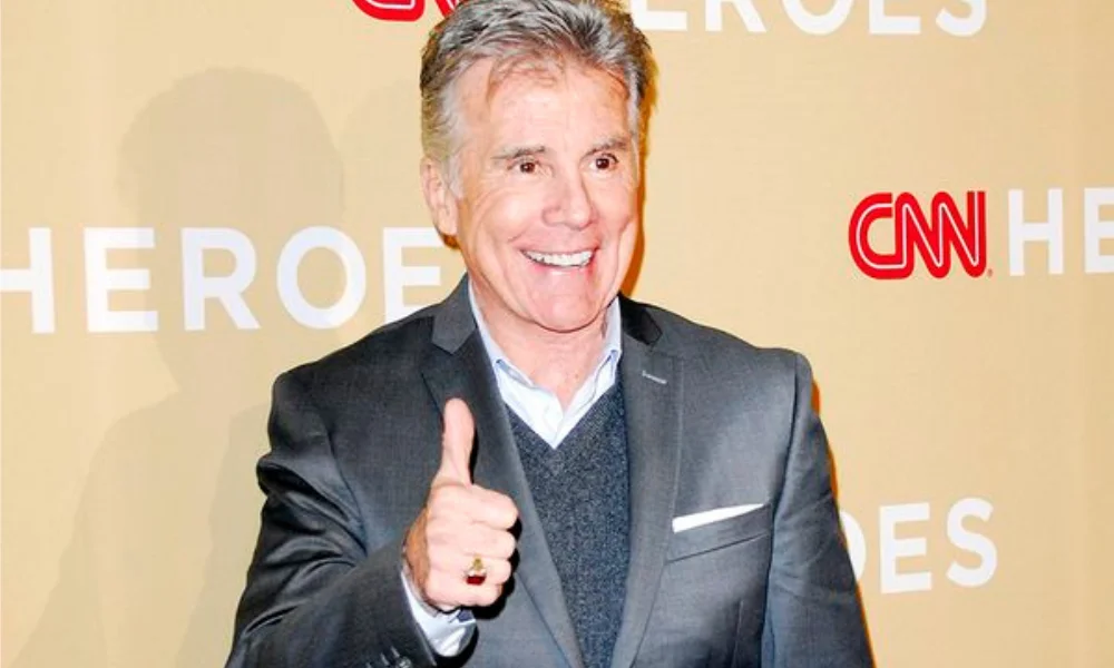 Smiling man in a suit gives a thumbs up-john walsh net worth