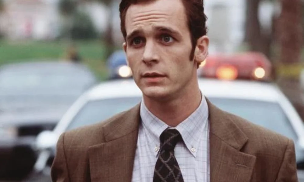 A man in a suit and tie stands outdoors with a worried expression-ethan embry's net worth