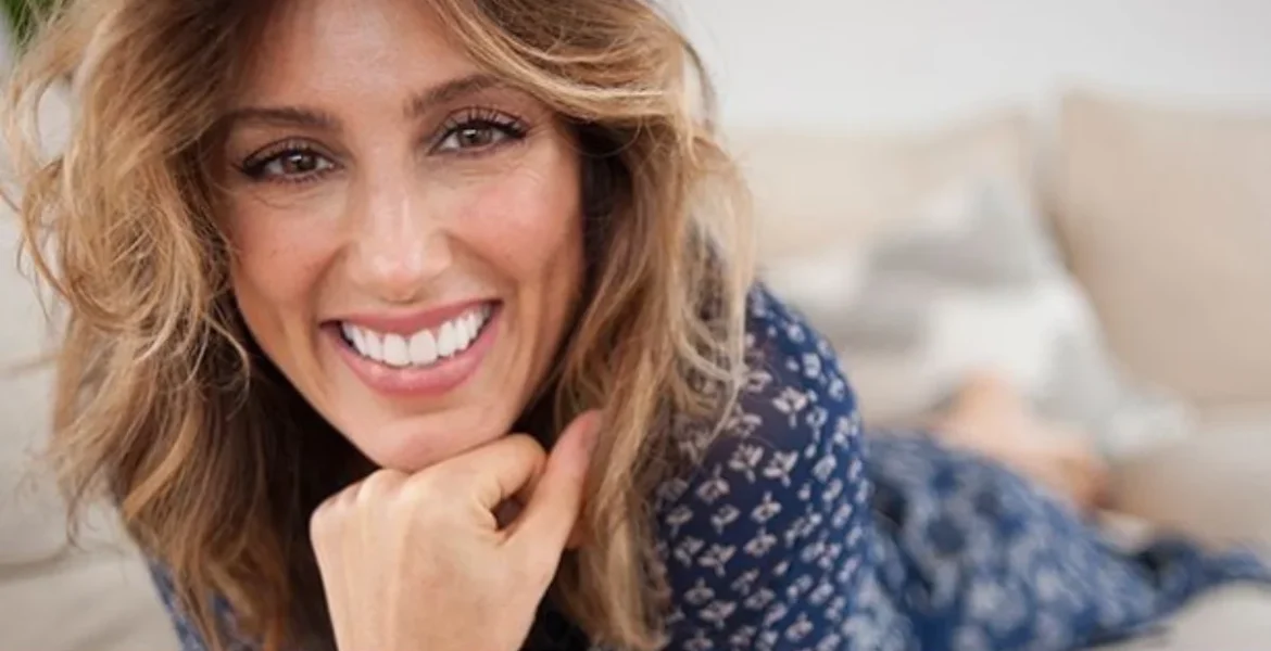 Smiling woman with wavy brown hair