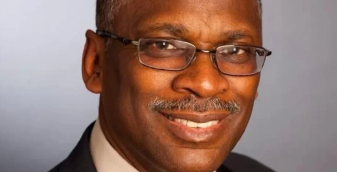 A smiling man with glasses and a mustache