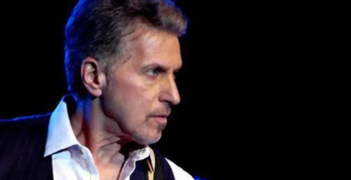 A man on stage, playing guitar