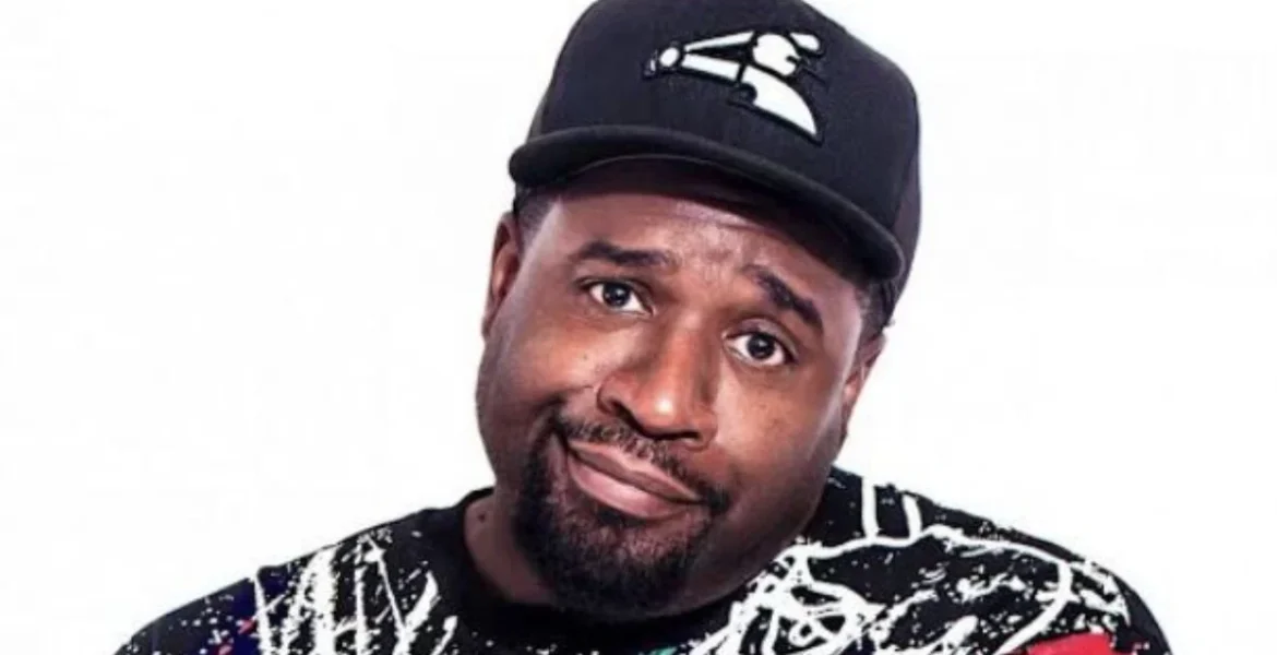 A man wearing a black cap with a logo