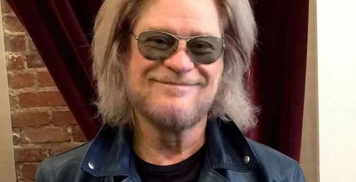 Smiling man with long, light hair