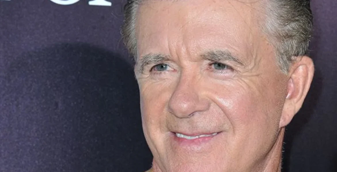 A smiling man with short, light hair