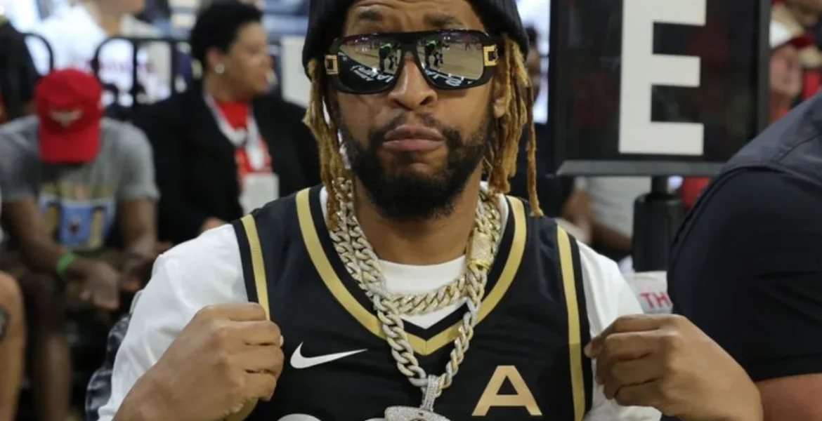 A person wearing sunglasses and a black basketball jersey