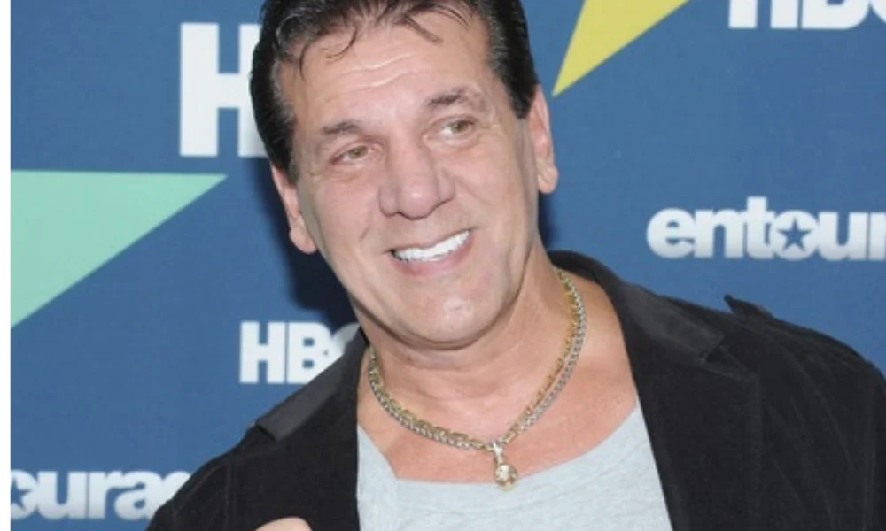 Smiling man in a blazer and gray shirt at an event-chuck zito net worth