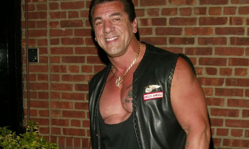 Smiling man in a black leather vest-chuck zito net worth