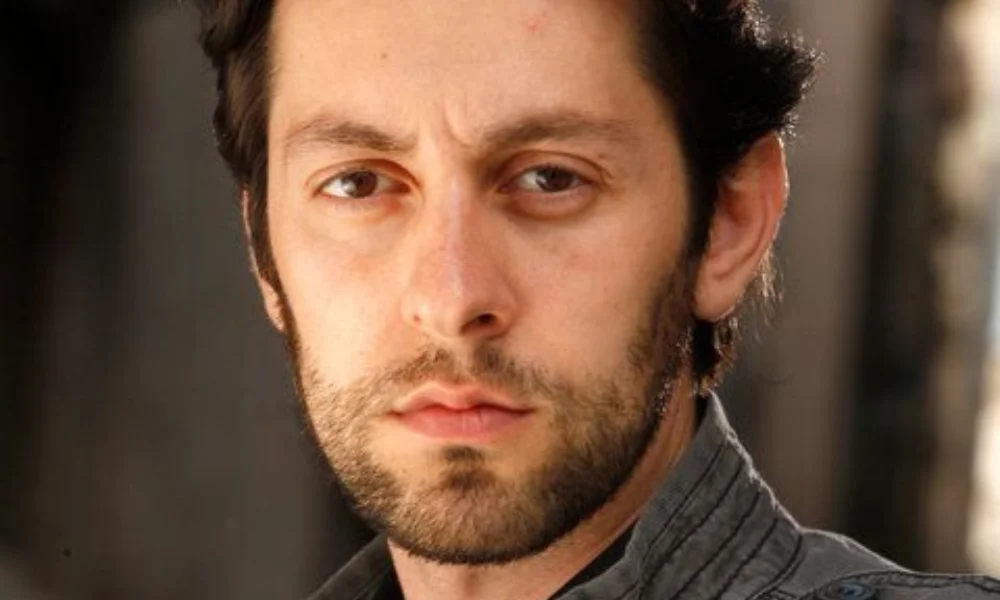 A man with dark hair-max amini net worth