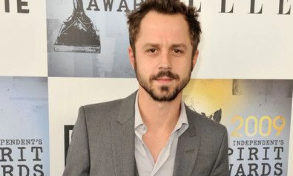 Man in a gray suit with a light blue shirt