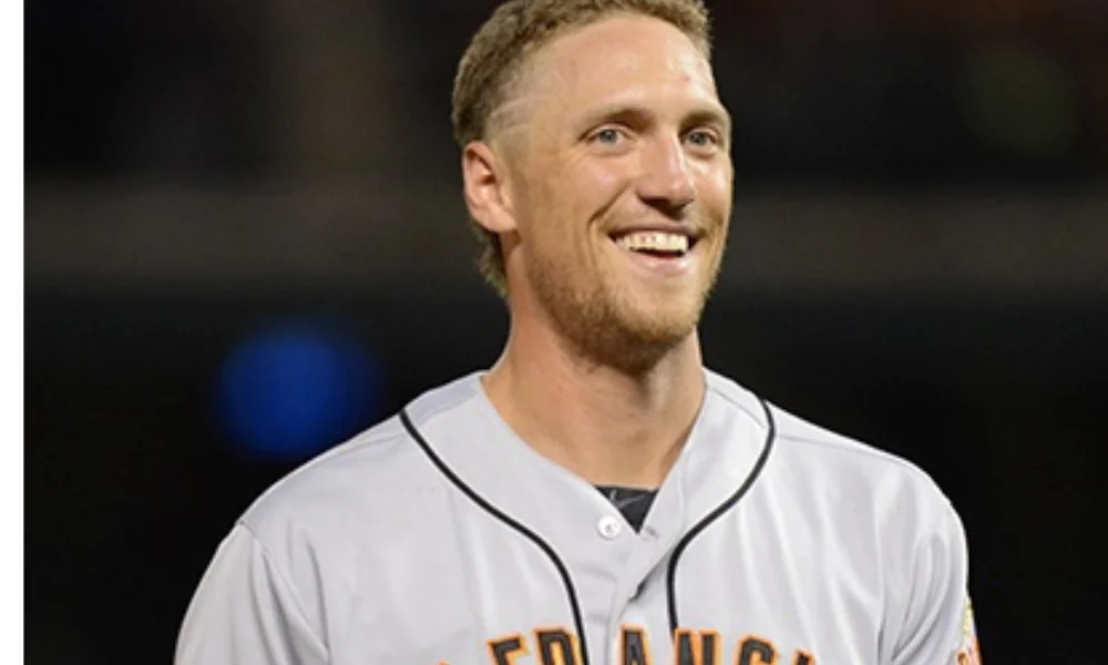 Smiling baseball player in a gray San Francisco Giants jersey