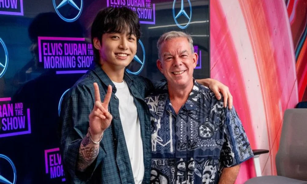 Two men smiling in a radio studio-elvis duran net worth