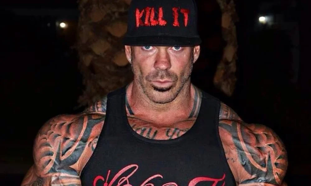 A muscular man with extensive tattoos