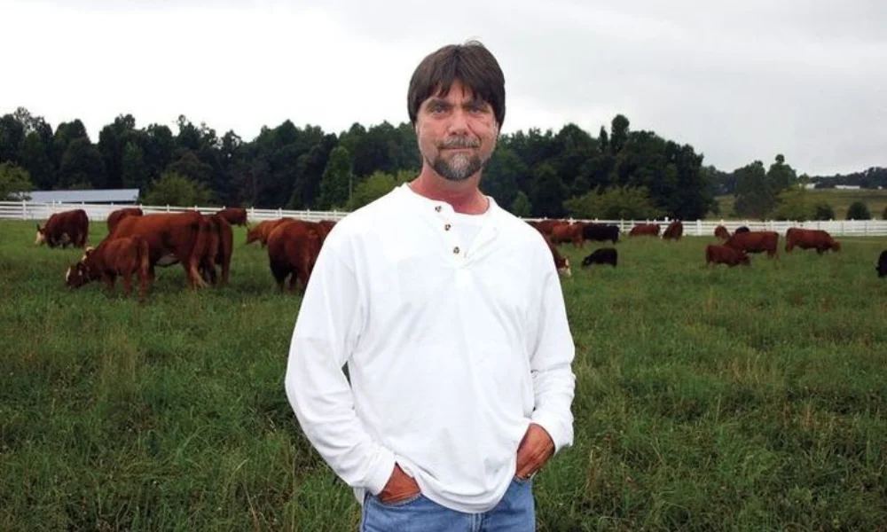A man in a white shirt stands confidently-teddy gentry net worth