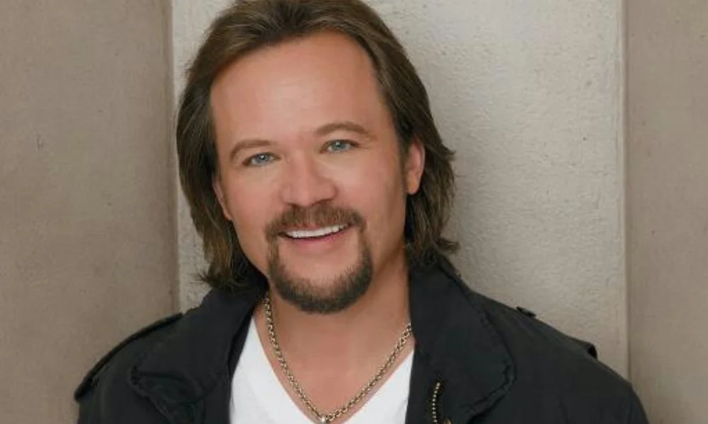 Smiling man with long brown hair and a goatee