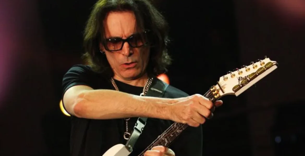 A musician passionately plays an electric guitar onstage