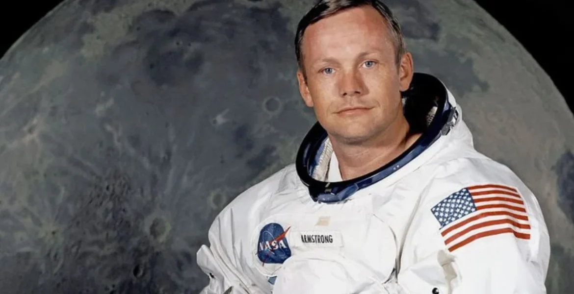 Astronaut in white NASA spacesuit with an American flag