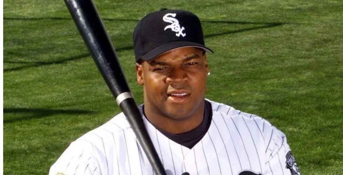 A baseball player in a white pinstripe uniform