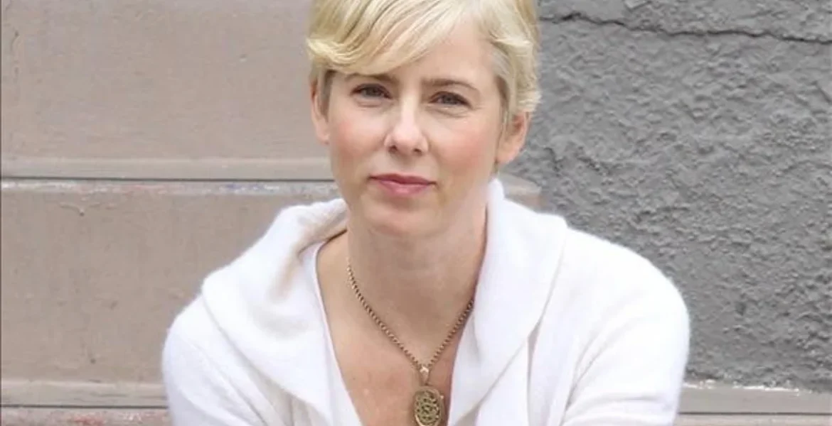 A blonde woman in a white sweater