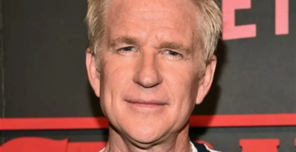 A man with short, light hair and a calm expression