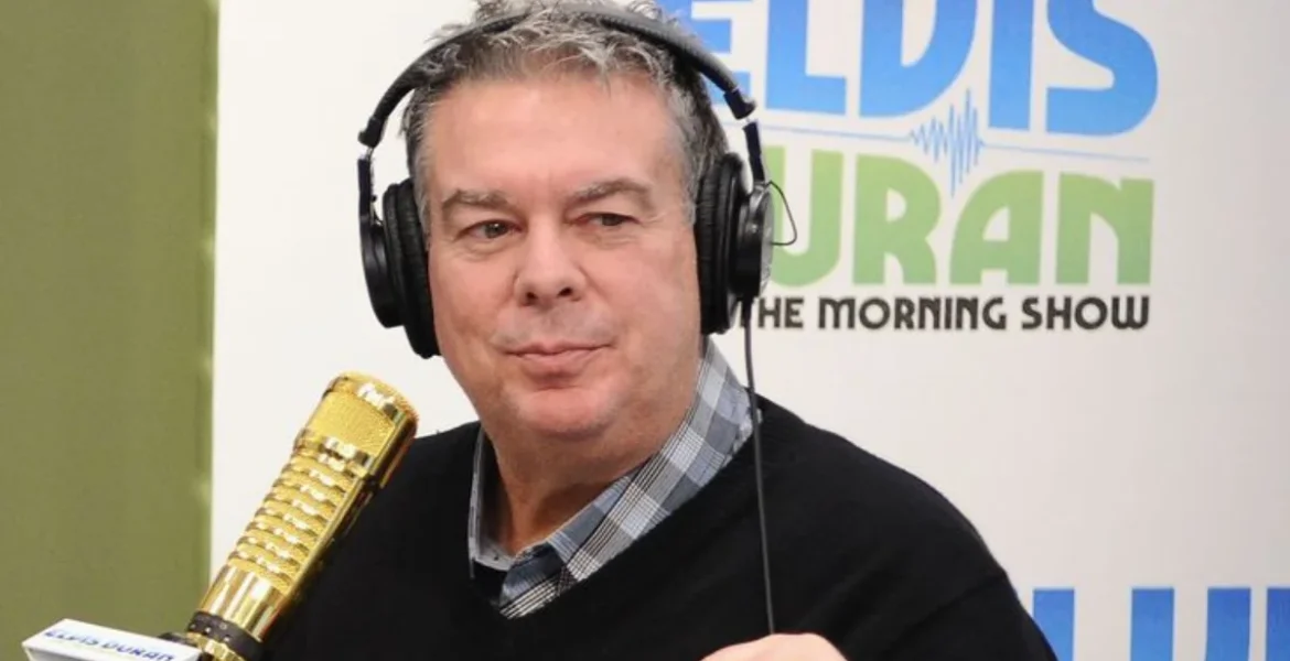 A person in headphones sits at a radio station