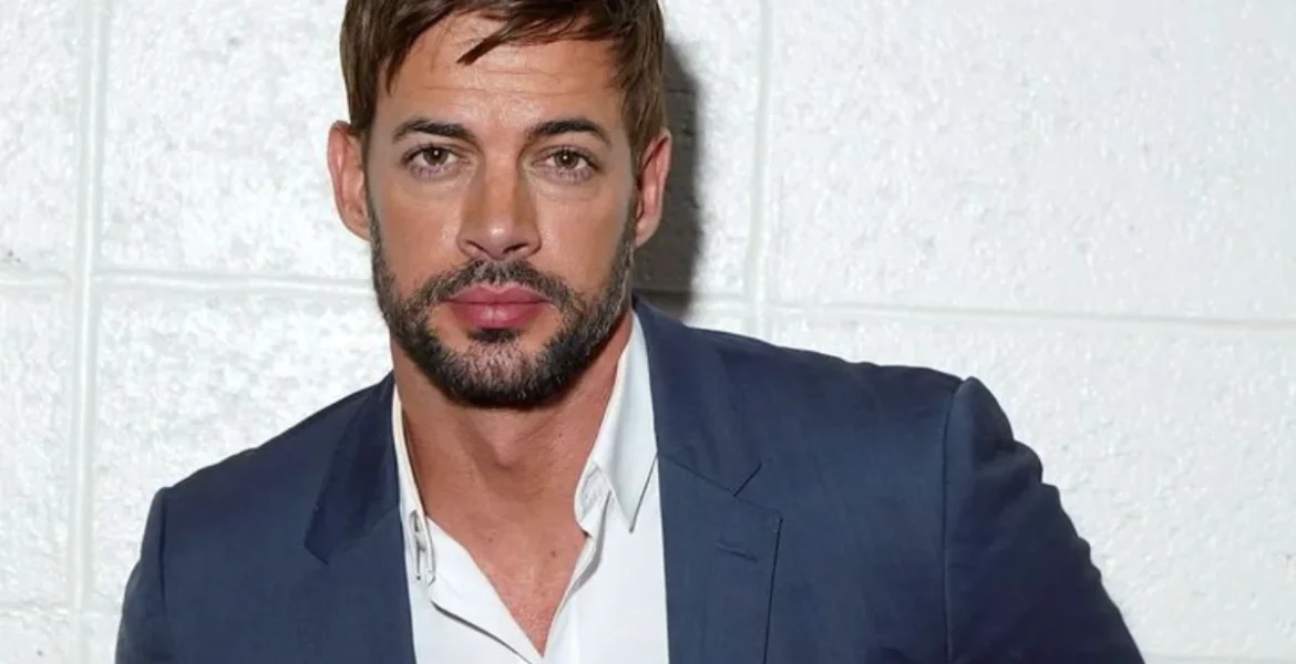 Man with short hair and a beard in a blue suit