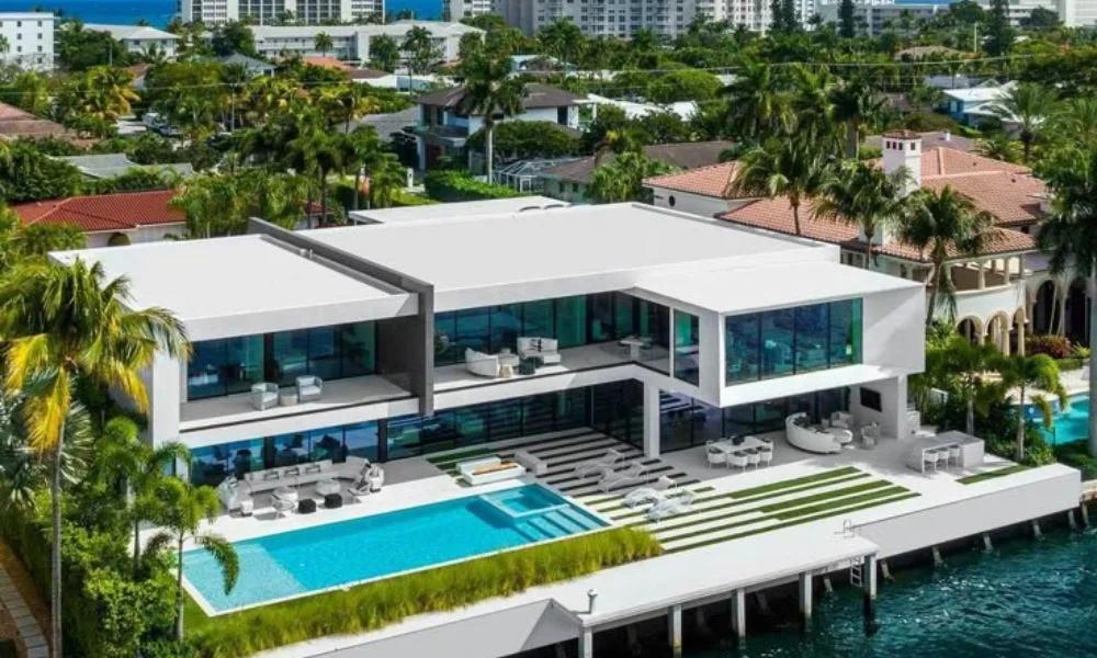 Modern waterfront mansion with floor-to-ceiling windows-luxury real estate trends