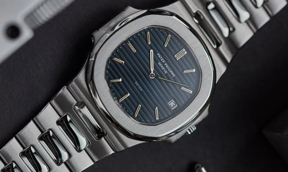 A sleek silver wristwatch with a blue, textured