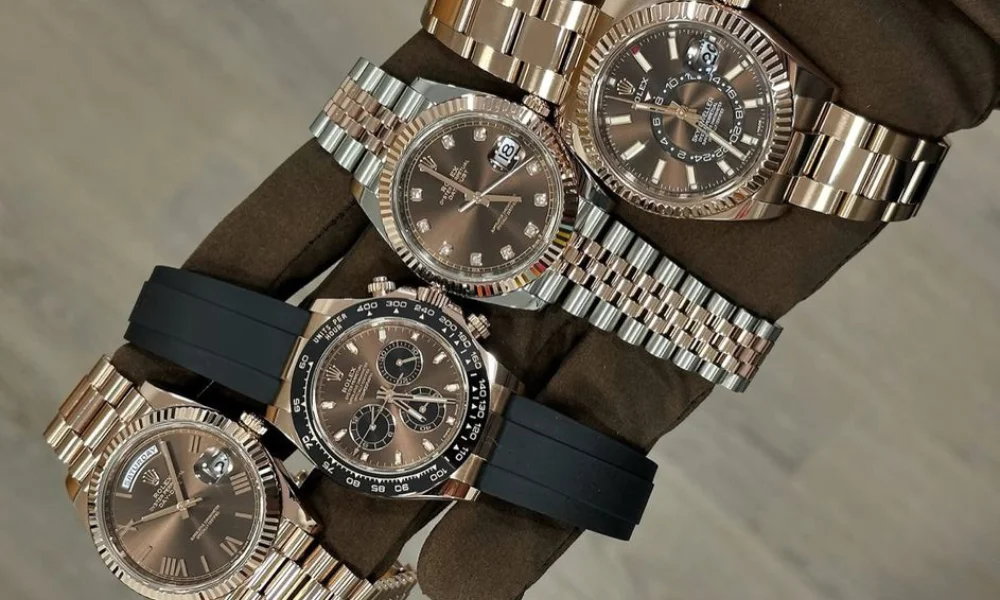 A gloved hand holds four luxury watches-luxury watches investment