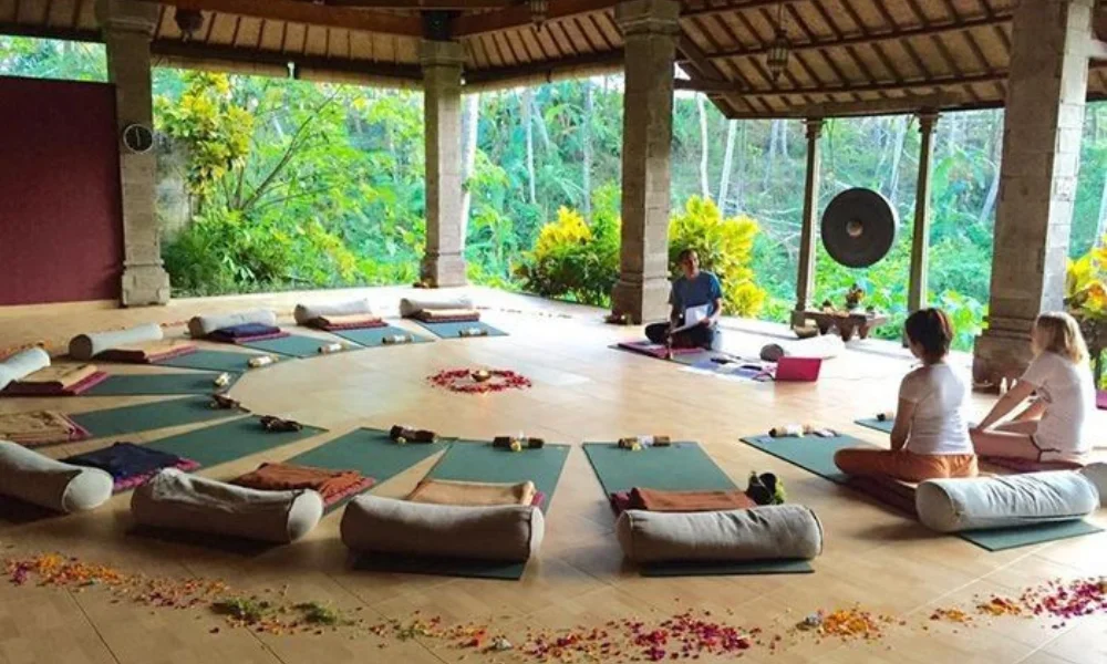 Three people sit meditatively-luxury mindfulness retreats