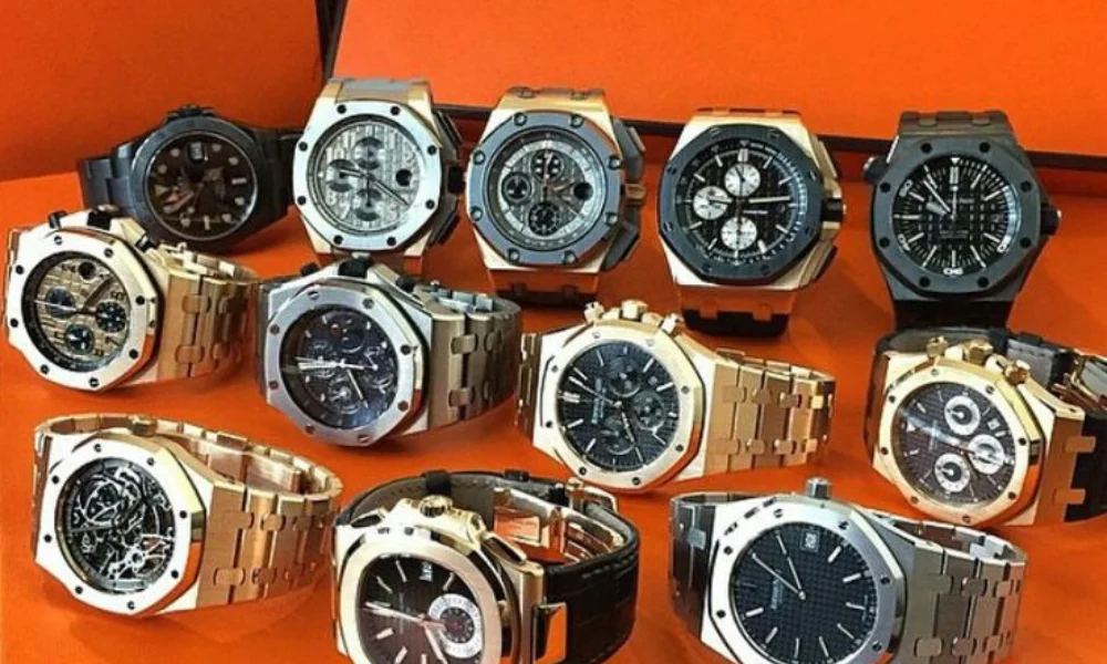 luxury wristwatches displayed on an orange surface