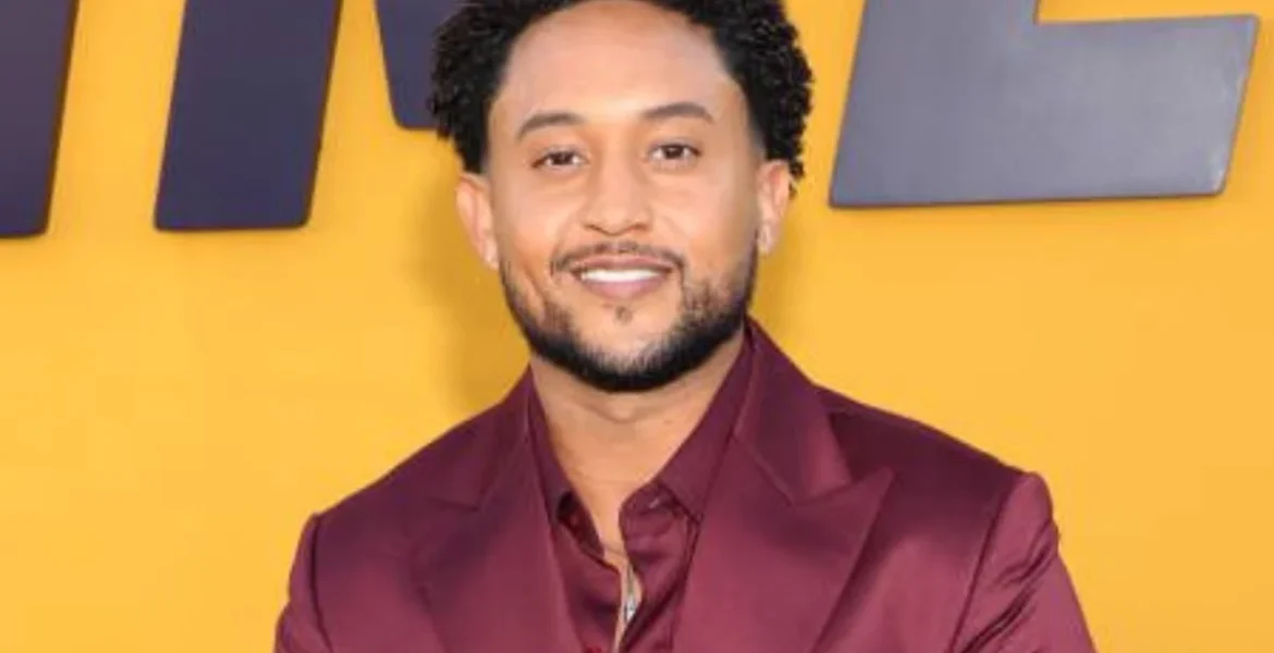 Smiling person in a maroon suit