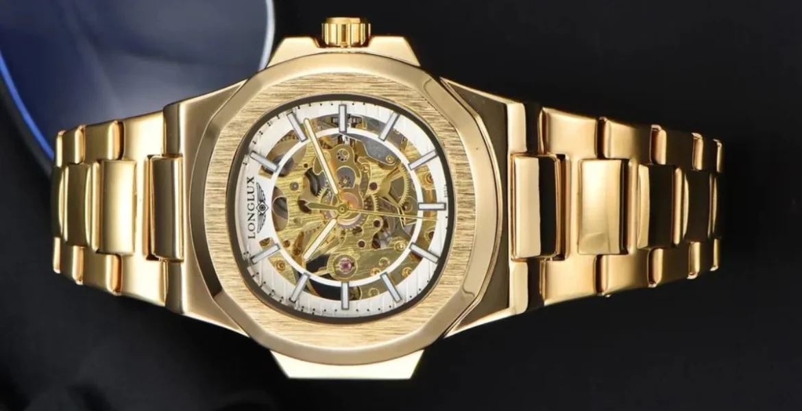 A gold wristwatch with a skeleton dial