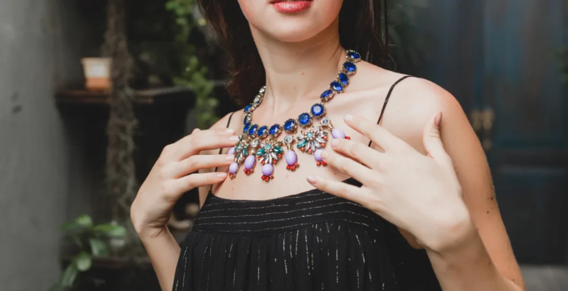 showcases an ornate necklace with blue and white gemstones